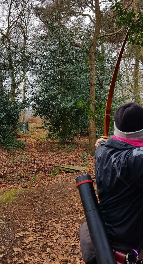Sharon shooting a 3D dragon target at Paget de Vasey