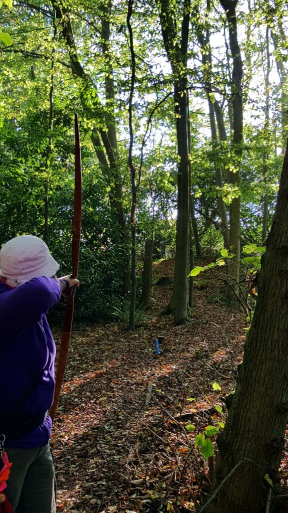 Sharon shooting the paper face tiger on the hillside