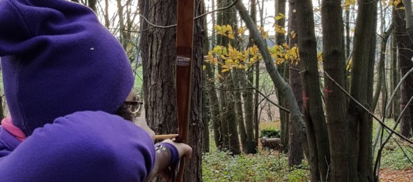 Sharon shooting a 3D between the trees