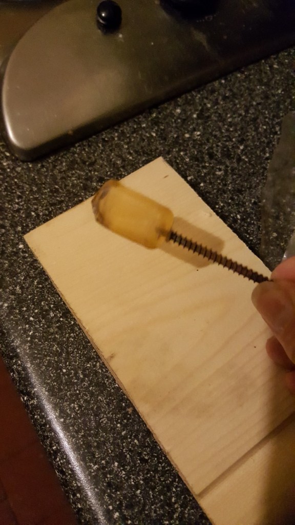 Hot-melt glue stub with a long wood screw attached
